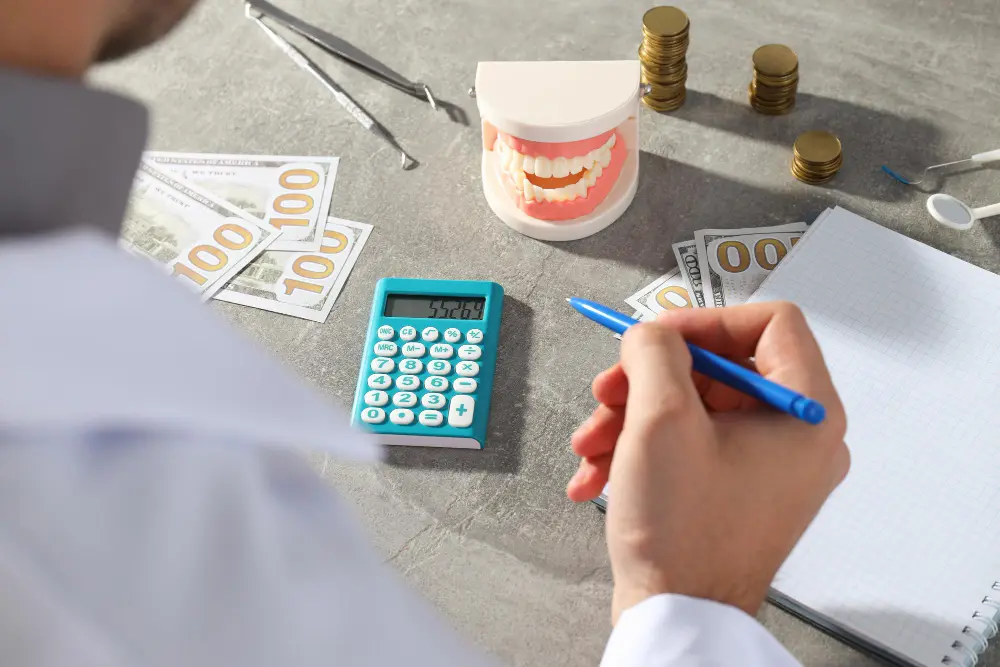 a person holding a pen and calculator next to money and a calculator