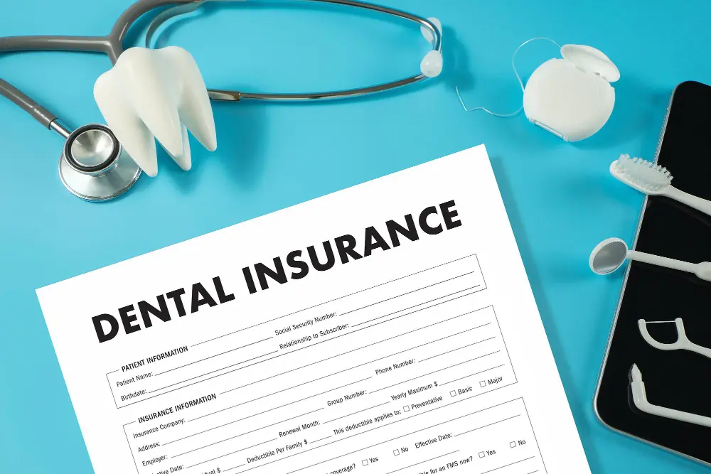a dental insurance form with a stethoscope and toothbrush