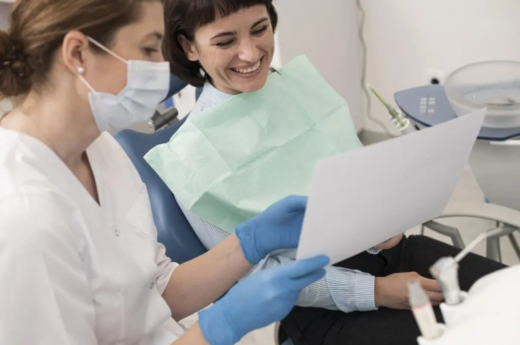 female patient looking radiography her teeth with dentist - Do I Need an Orthodontist for Invisalign? Limestone Hills Orthodontics Austin TX