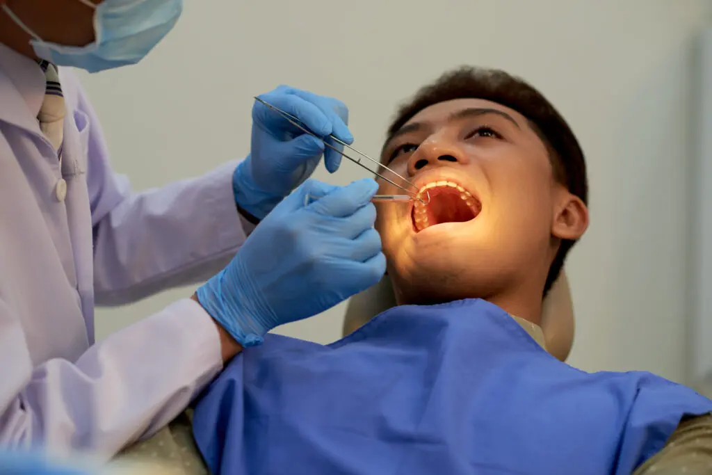 Young patient visiting dentist to have annual teeth examination - Can You Speed Up Orthodontic Treatment? What Works and What Is Hype