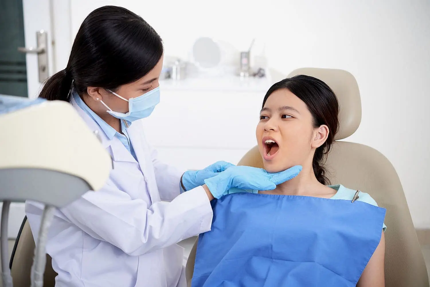 Orthodontist examining a young patient’s mouth during consultation, representing airway orthodontics for improving breathing and health. Limestone Hills Orthodontics in Austin, TX offers treatment to address mouth breathing issues.