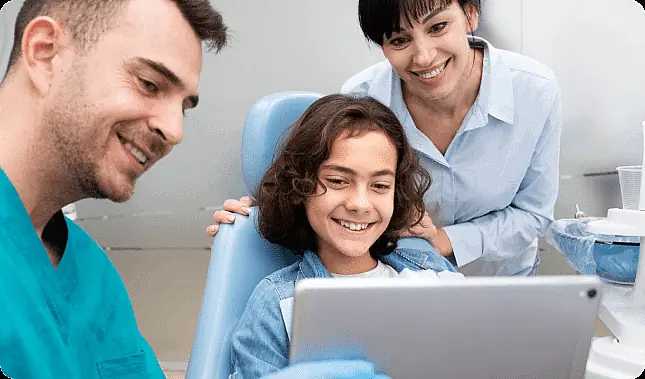 Young patient with dental professional discussing appointment duration at Limestone Hills Orthodontics, Austin, TX Young patient with dental professional discussing appointment duration at Limestone Hills Orthodontics, Austin, TX