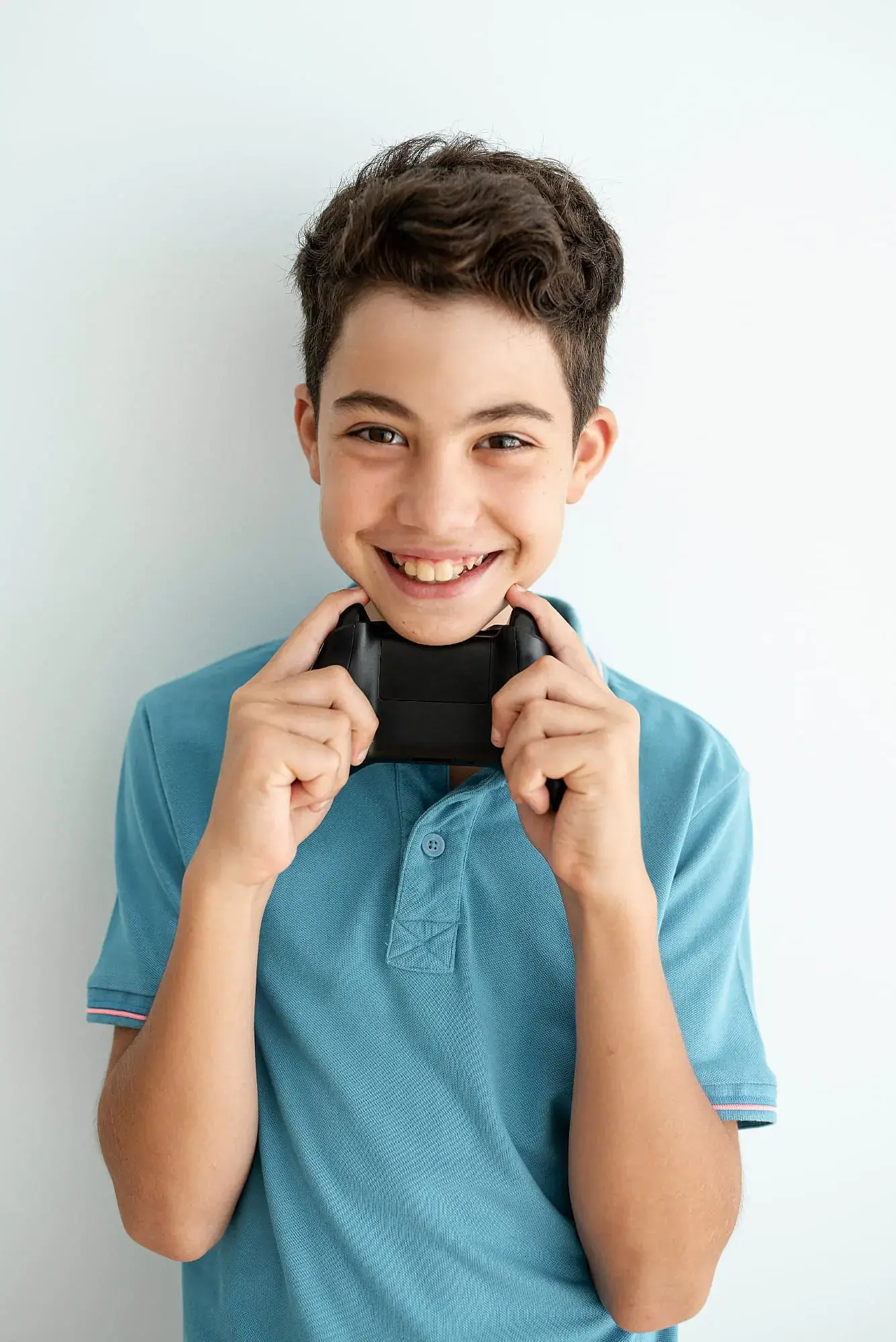 Teenage boy smiling while learning about overbite, underbite, and crossbite at Limestone Hills Orthodontics, Austin, TX Teenage boy smiling while learning about overbite, underbite, and crossbite at Limestone Hills Orthodontics, Austin, TX