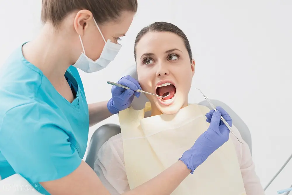 Dentist examining a patient during an oral checkup, illustrating How Orthodontics Supports Overall Health in Austin, TX