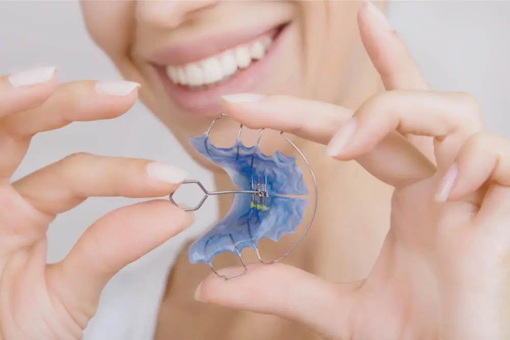 beautiful smiling girl with retainer for teeth close up