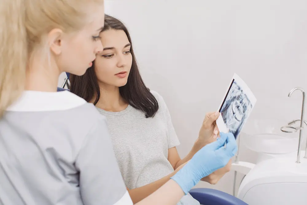 orthodontist showing x-ray image to patient - How Orthodontic Insurance Works in Austin, TX