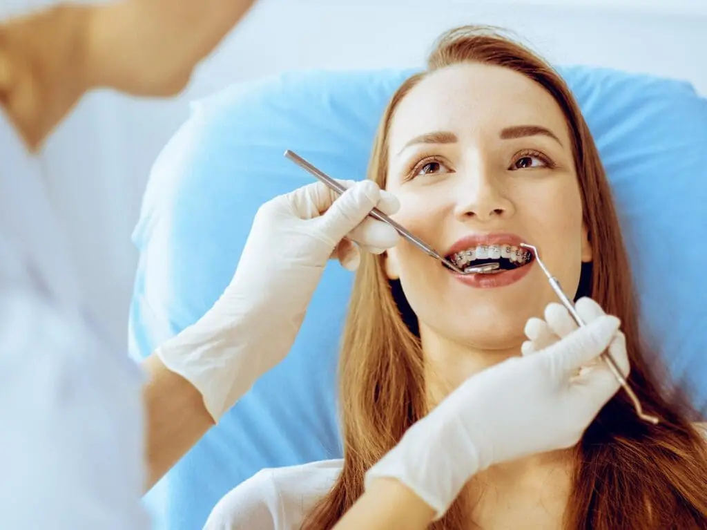 A young woman gets Teeth Gaps, Spacing Treatment, and Accelerated Orthodontic Treatment with braces at Limestone Hills Orthodontics in Austin, TX.