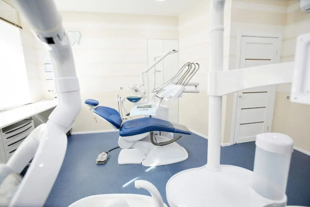 A clean, modern exam room for fitting an airway appliance at Limestone Hills Orthodontics in Austin, TX, featuring medical cabinets, a sink, advanced equipment, and bright lighting.