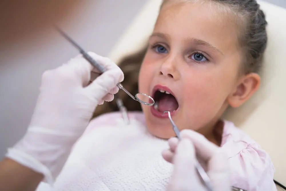children visiting dentist mouth orthodontst checkup treatment - Best Age for Braces: An Age-by-Age Timeline 