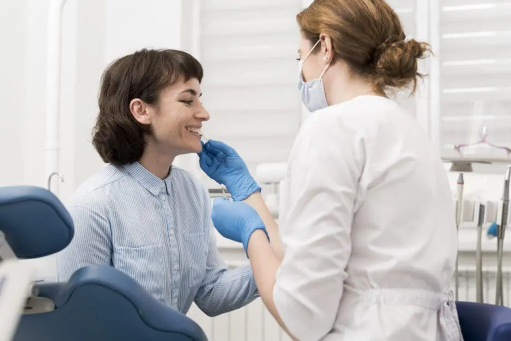 female patient having procedure done dentist - Questions to Ask at Your Orthodontic Consultation: A Complete Checklist | Limestone Hills Orthodontics Austin TX