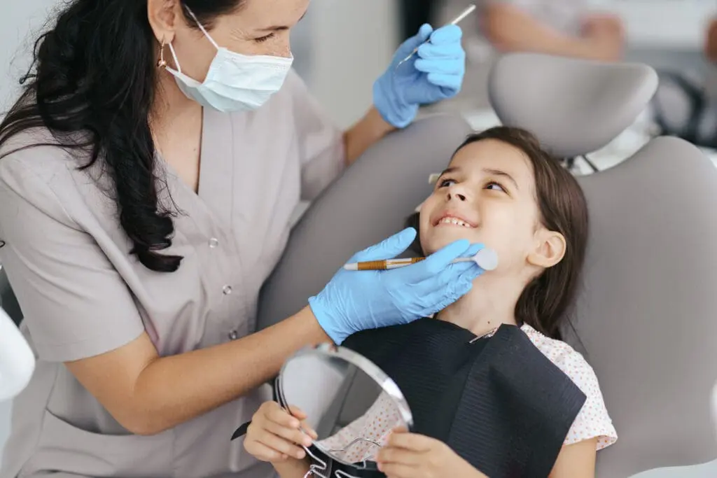 little beautiful girl dentist smiling - First Orthodontist Visit for Kids: What Parents Should Know | Limestone Hills Orthodontics Austin TX